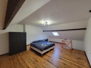 a bedroom with a bed in an attic at Maison proche gare in Margny-lès-Compiègne