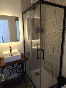 a bathroom with a glass shower and a sink at SG Estudios Sanlúcar in Sanlúcar de Barrameda +12 photos