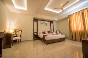 a bedroom with a bed and a ceiling fan at Hotel Star Palace - Rameswaram Tamil Nadu in Rāmeswaram