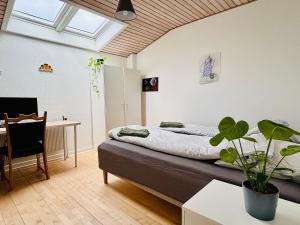 a bedroom with a bed and a table and a desk at PRIVATE B&B - EASY ACCESS - 24h SELF CHECK IN-OUT in Odense