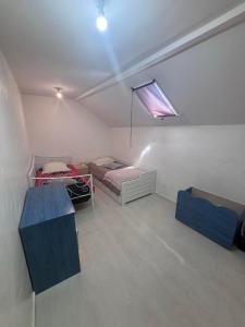 a room with two beds and a window in it at maison de loire in Villebernier