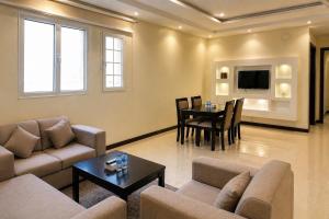 a living room with a couch and a table at سويت tolan in Hail +5 photos