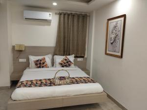 a bedroom with a bed with a basket on it at Gianmala Residency South Ex New Delhi in New Delhi