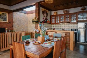 a kitchen with a wooden table with food on it at Umah Sunset in Ubud