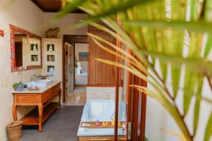 a bathroom with a tub and a sink and a mirror at Umah Sunset in Ubud +29 photos