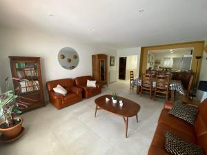 a living room with a couch and a table at Frangipanier, Maison quartier calme, 1,5km de la plage, 6 pers in Les Sables-d'Olonne