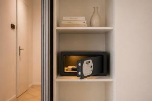 a small tv on a shelf in a room at Princess Palace Monaco in Monte Carlo
