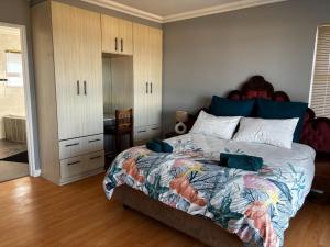 a bedroom with a bed with two pillows on it at Wild Thyme in St Helena Bay in West Point