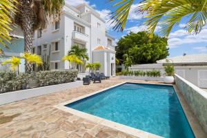 a swimming pool in the backyard of a house at Luxury Seafront 4p large ground floor apartment in Kralendijk
