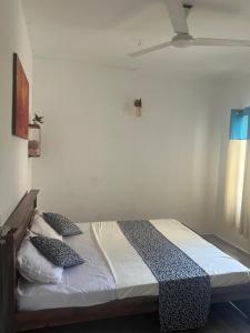a bedroom with a bed with pillows on it at Two room flat in colombo 5 in Narahenpita