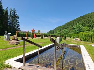 a garden with a pond with crosses in it at Naturhotel Lindenhof in Rechenberg-Bienenmühle