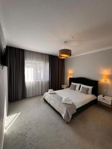 a bedroom with a large bed and a window at Royal Boutique in Râşnov +27 photos