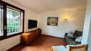 a living room with a couch and a television at A casa nostra in Formello