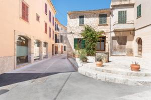 an empty street in an old town with buildings at Can Calco old town in Alcudia
