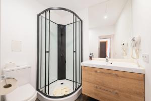 a bathroom with a shower and a toilet and a sink at Can Calco old town in Alcudia +42 photos