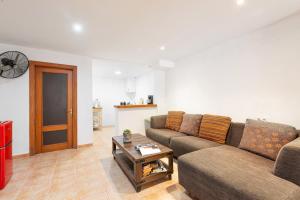 a living room with a couch and a table at Can Calco old town in Alcudia