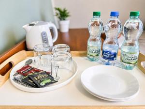 a table with two bottles of water and glasses on it at Willa Park in Zakopane