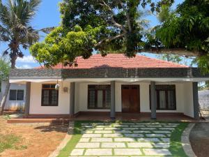 a small house with a red roof at The Yarl Home in Jaffna