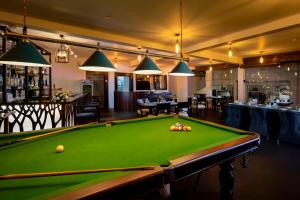a pool table in a room with a bar at The Pinnacle Ella Boutique Hotel and Spa in Ella