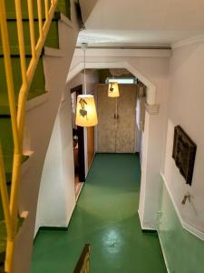 a hallway with a green floor in a building at Boutique Florence in Ermoupoli