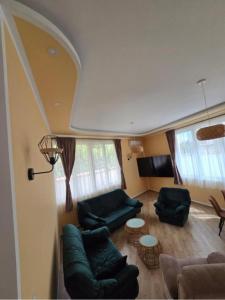 a living room with two couches and a table at Villa Iper Krystallos in Budva