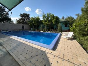 a swimming pool in the backyard of a house at May weather Resort Family G House in Bukhara