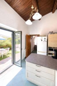 a kitchen with a counter top and a refrigerator at Paradise House in Maratea
