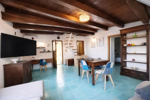 a kitchen and dining room with a table and chairs at Paradise House in Maratea