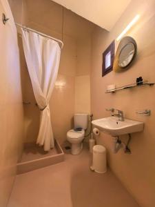 a bathroom with a toilet and a sink and a mirror at Boutique Florence in Ermoupoli +60 photos
