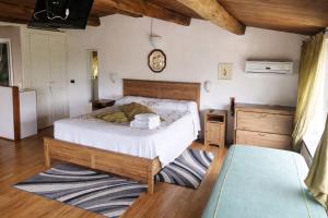 a bedroom with a bed and a clock on the wall at Paradise House in Maratea +8 photos