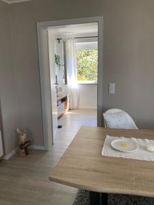 a dining room with a table and a window at Ferienwohnung Hollmann in Kaufbeuren +11 photos