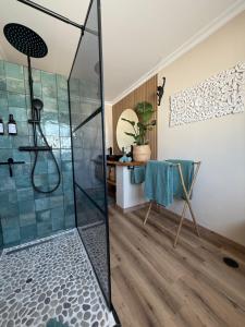 a bathroom with a shower with a glass shower stall at Casa Sol e Sal in Luz +71 photos