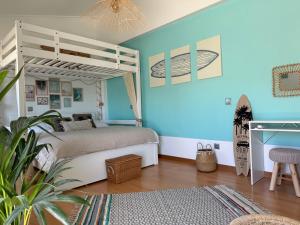 a bedroom with a white bunk bed and a rug at Casa Sol e Sal in Luz