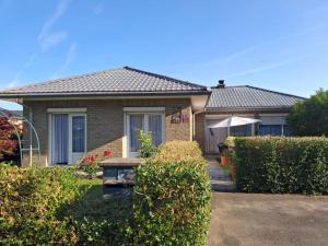 a house with a garden and bushes at Les Mésanges Bleu in Malmedy