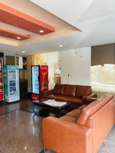 a living room with a couch and a coffee table at hotel fortune city in Bangalore