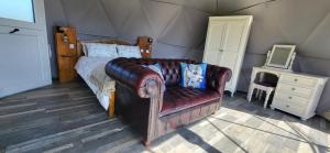 a living room with a couch and a bed at alpaca view Dome in New Holland