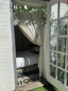 a small room with a bed and a window at Honeydon in Eaton Socon