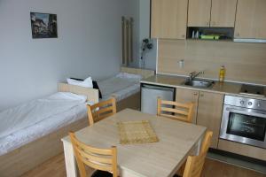 a small kitchen with a table and a kitchen with a couch at Aspen Heights 4 beds studio in Bansko
