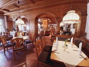 a dining room with a table and chairs at Naturhotel Lindenhof in Rechenberg-Bienenmühle