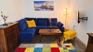 a living room with a blue couch and a table at Calle Bottari ChioggiaPL in Chioggia +33 photos