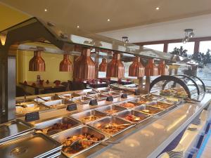 a buffet line with many trays of food at Asia wok gasthof in Ybbs an der Donau +32 photos