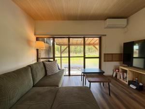 a living room with a couch and a table at 近露の家 -chikatsuyunoie- in Tanabe