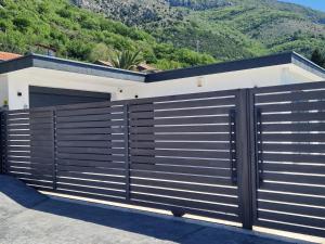 a modern house with a black and white fence at Villa Maja in Sutomore