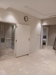 ein Zimmer mit einer weißen Tür und einer Uhr an der Wand in der Unterkunft دور ارضي كبير وواسع للضيافة والتحويل لحسابي بعد الوصول للمنزل in Riad + 20 Fotos