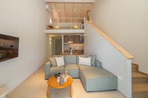 a living room with a couch and a table at Cavaliere Seafront House - Thalia in Sami