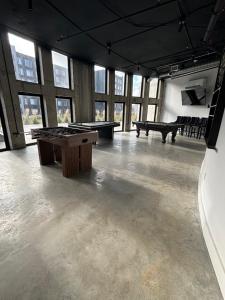 a large room with two ping pong tables and windows at Lafayette in Elizabeth