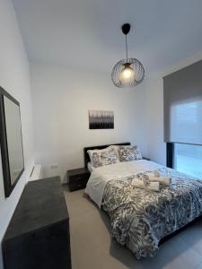 a bedroom with a large bed and a table at Meintis Apartments Rafina in Rafina +92 photos