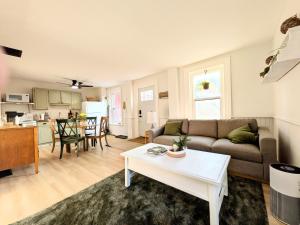 a living room with a couch and a table at Red Roof Guesthouse in Cobourg