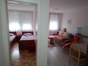 a room with a living room with a couch and a table at Visnja in Gornja Toplica