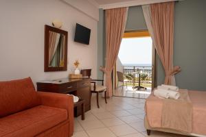 a living room with a couch and a chair at Finiki Plaza in Methoni